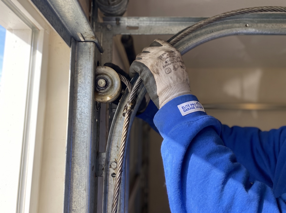 Close-up of garage door cable and roller repair